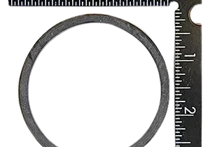 Metal ring measured with black ruler.