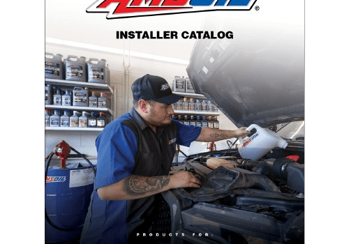 Mechanic pouring oil into car engine.