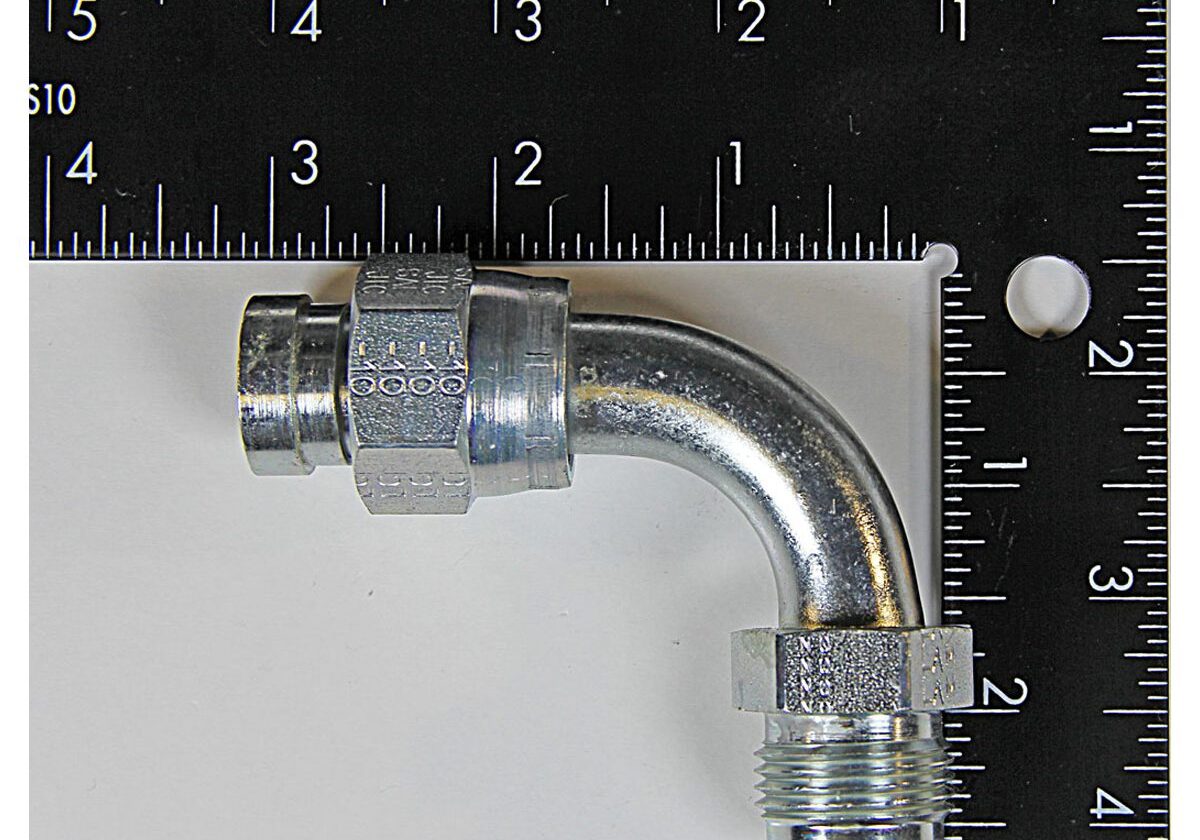 Metal elbow pipe fitting with ruler scale.