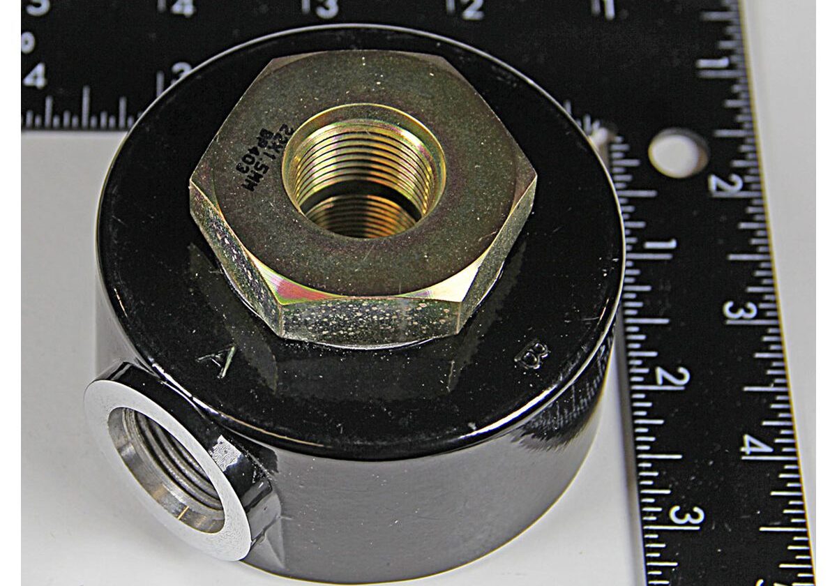 Metal adapter with rulers for scale.