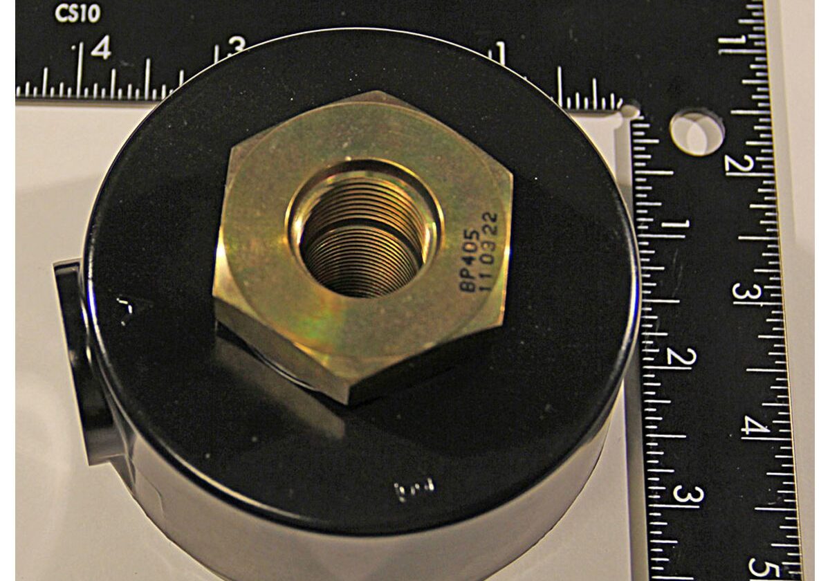 Metal coupling with measuring rulers nearby.