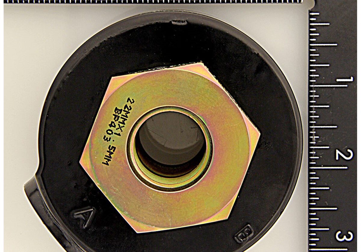 Ruler and large hexagonal nut close-up.