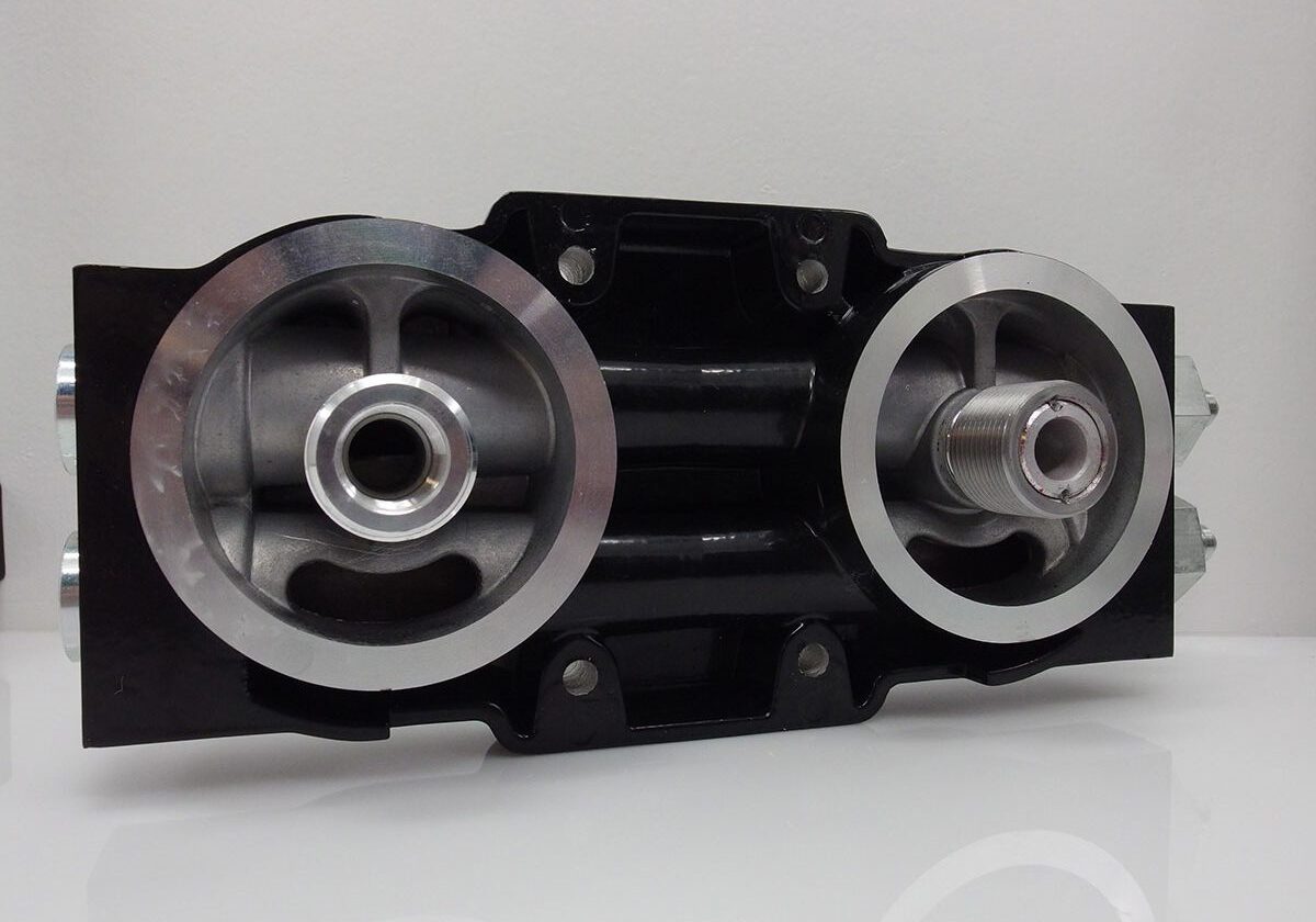 Metal hydraulic manifold with circular connections.