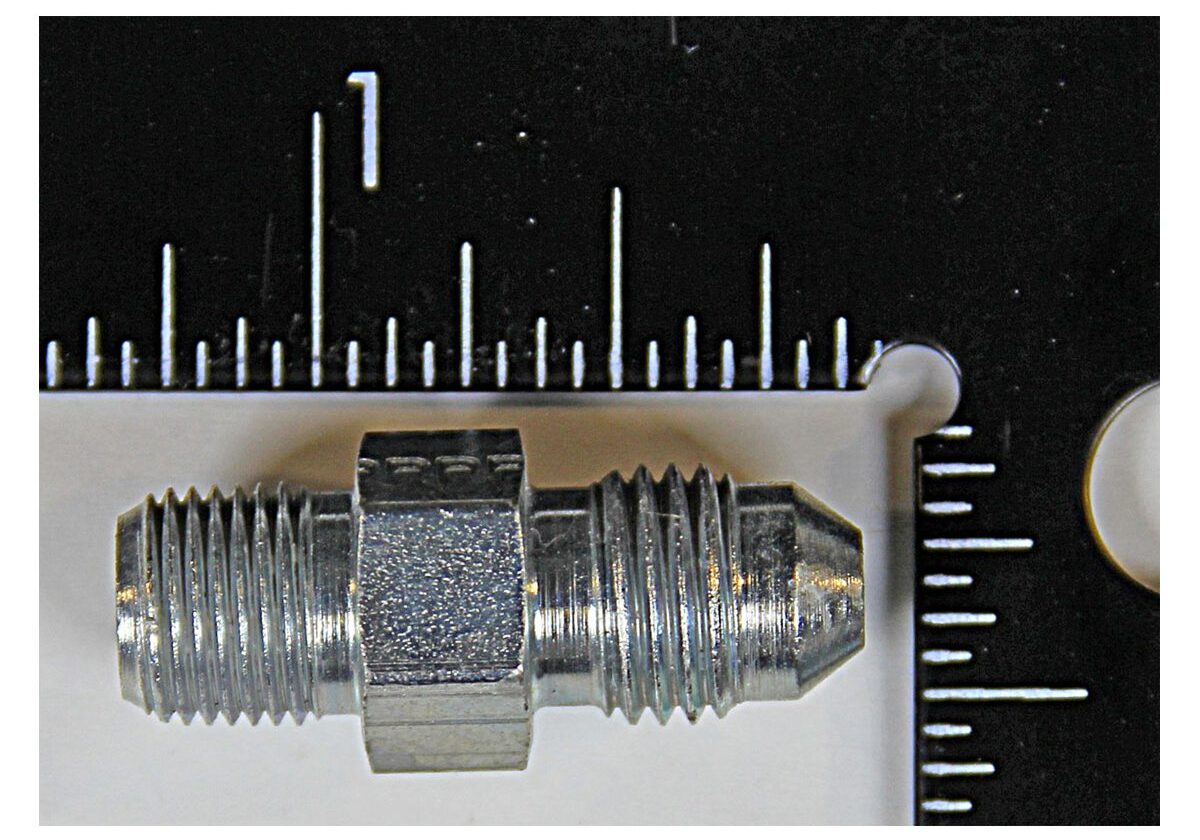 Metal fitting next to a black ruler.