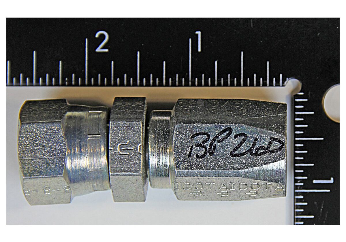Metal fitting with ruler for scale.
