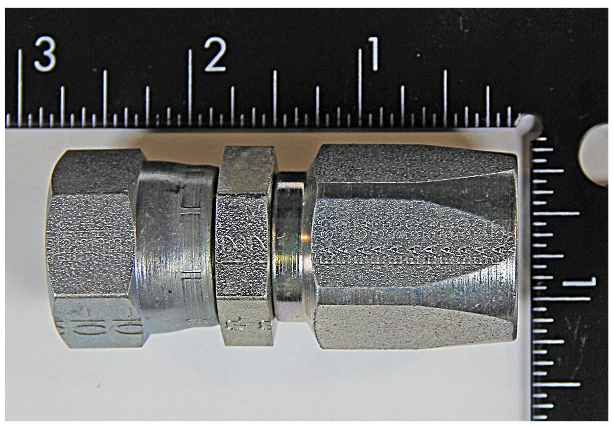 Metal connector with ruler for scale.