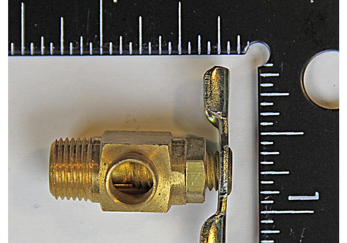 Brass valve with wingnut and ruler.