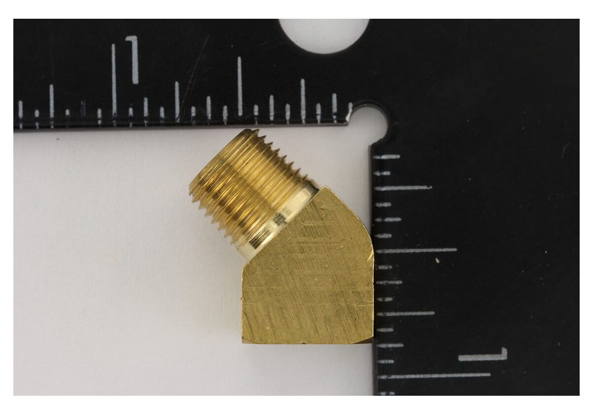 Brass elbow fitting with measuring rulers.
