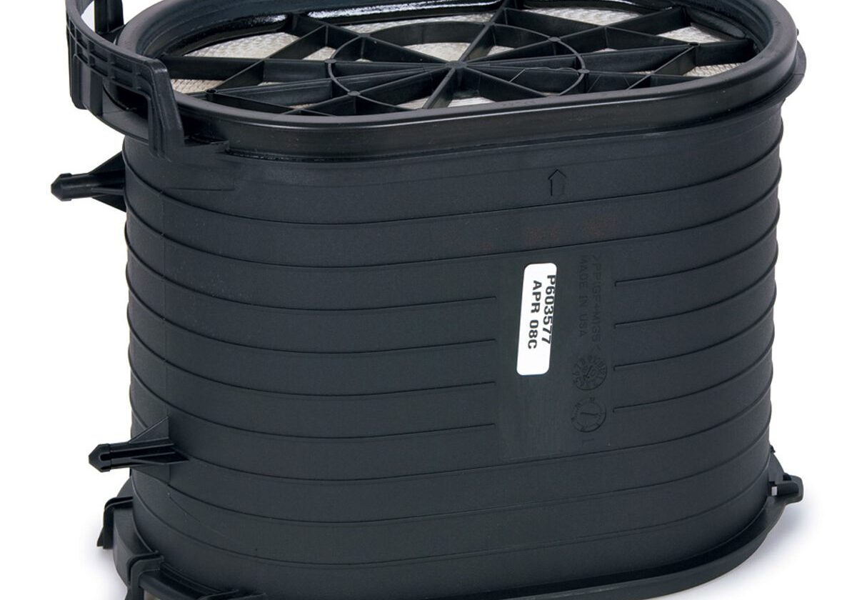 Black cylindrical air filter with label.
